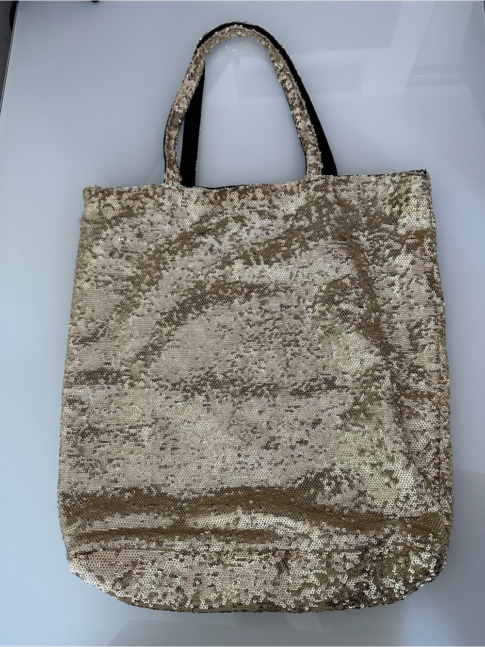 Gold sequined tote bag, lightweight, lined in black fabric inside.